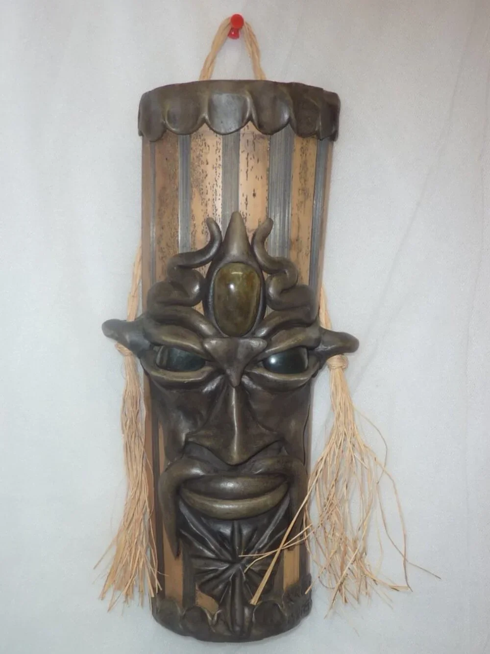 Clay mask on wood. Size 12 x 4 1/2 x 2 1/2 inches by artist Krisna Brasil